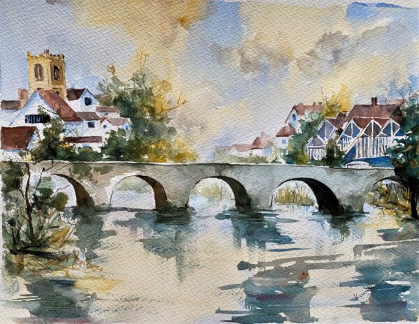 A watercolour painting of a quintessential English town showing a bridge over the river and the surrounding houses.